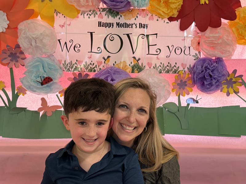 Moms and son smiling