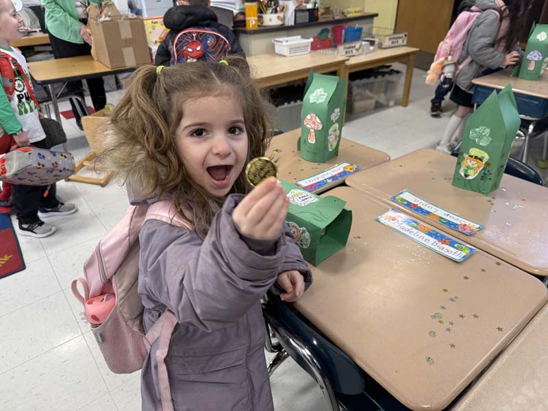 Student holding a gold coin