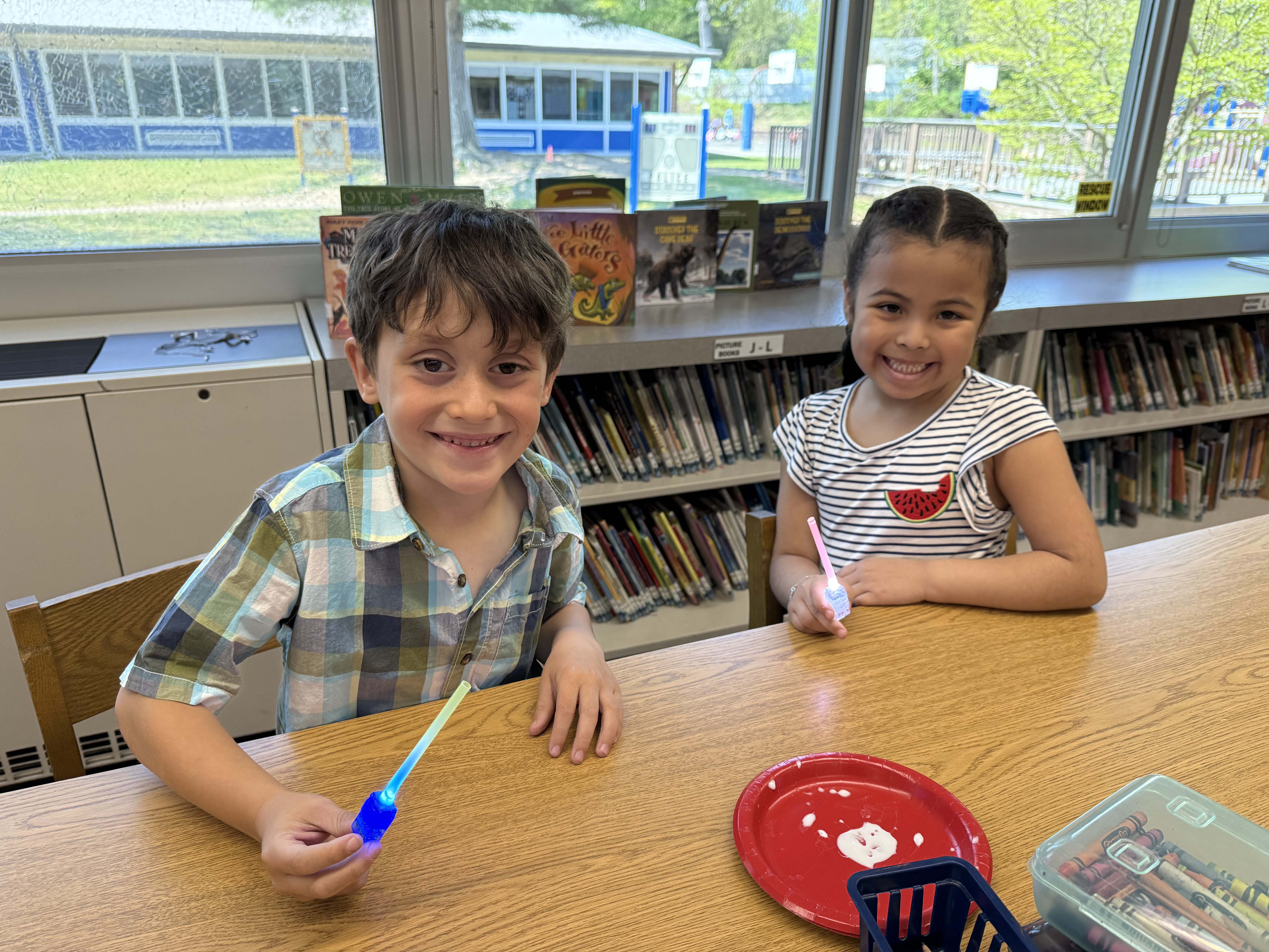 students smiling at a table