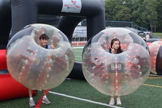 students in inflatable balls