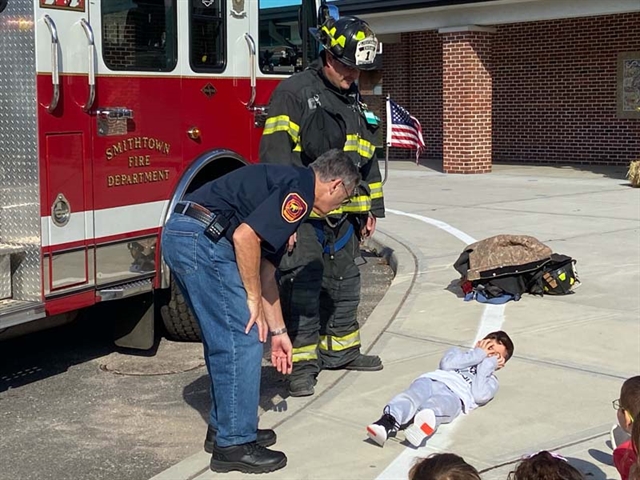 student lying down for firefighter