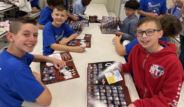 Students looking through yearbook