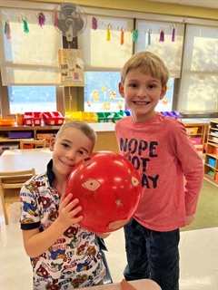 Students smiling with animal balloons