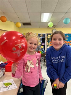 Students smiling with animal balloons