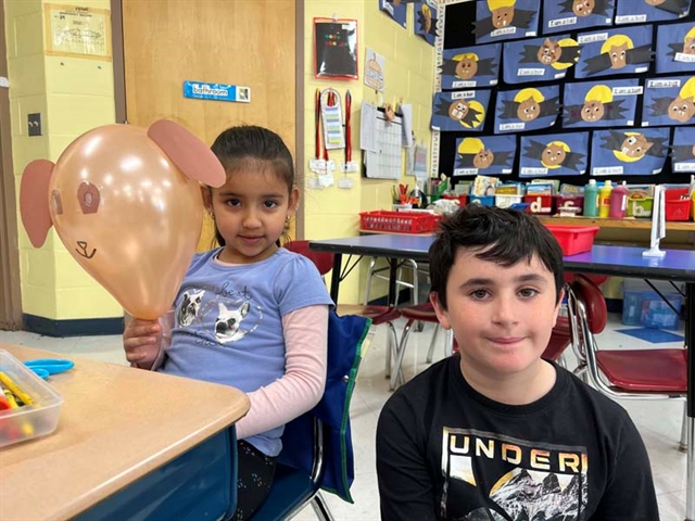 Students smiling with animal balloons