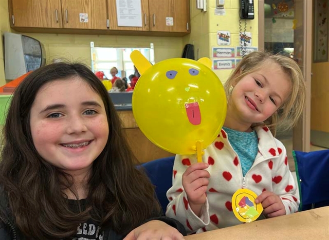 Students smiling with animal balloons