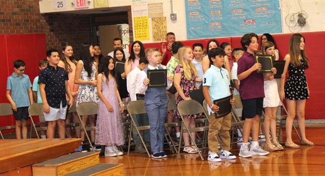 students standing for graduation