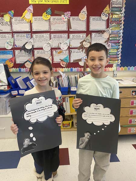 students holding artwork with dreams on them