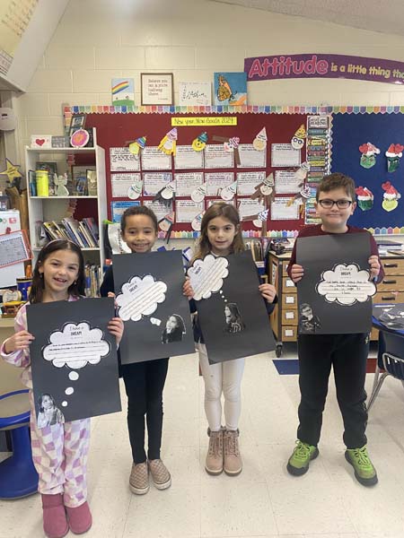 students holding artwork with dreams on them