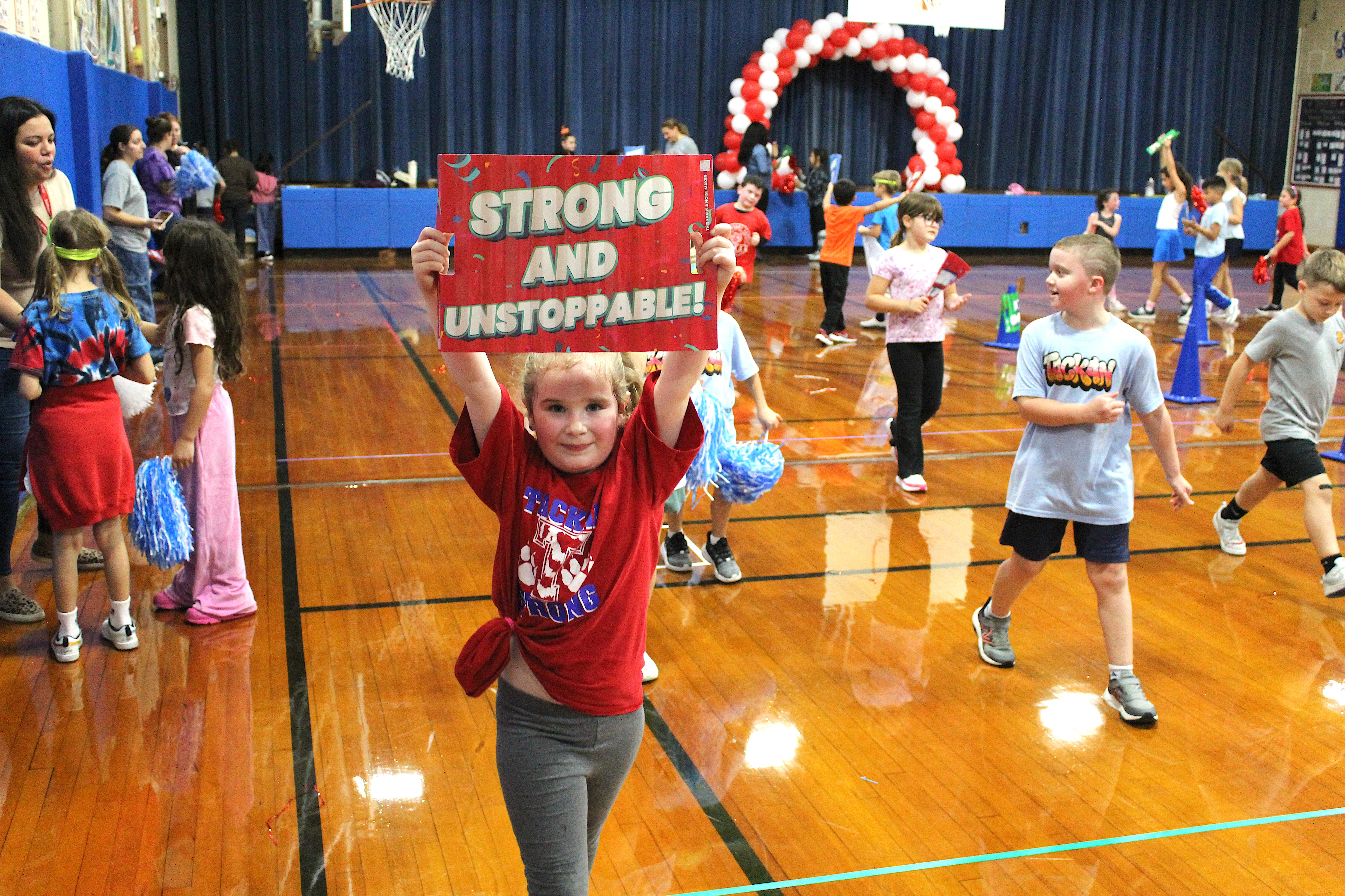 student holding a sign and running