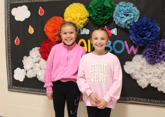 Students wearing pink and smiling