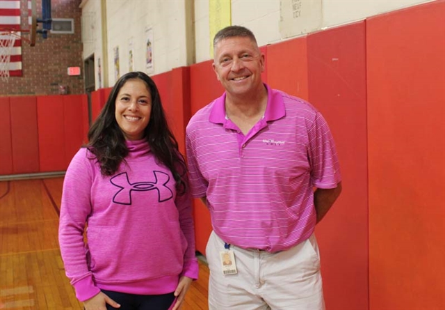 Staff wearing pink and smiling