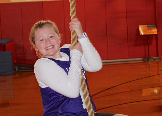 student on rope smiling