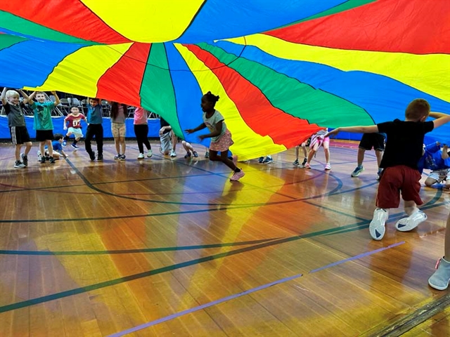 children playing under the parachute