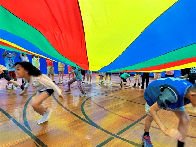 children playing under the parachute