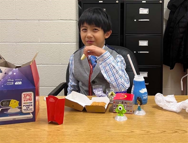 Oz at the desk smiling