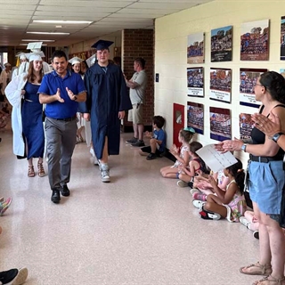 principal and students walking