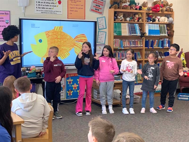 Students doing sign language at Mt. Pleasant