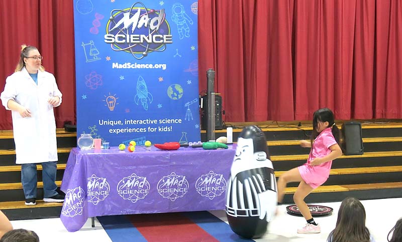 Student doing science experiment on stage