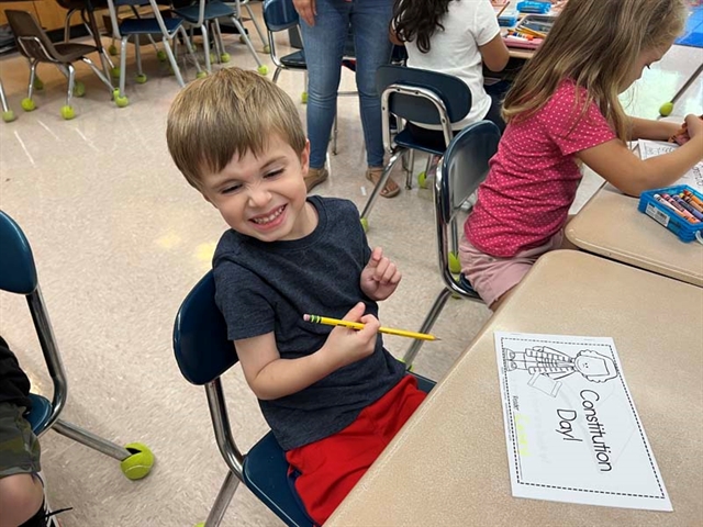 students in classroom smiling