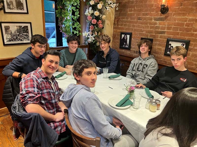 Students smiling for picture in restaurant