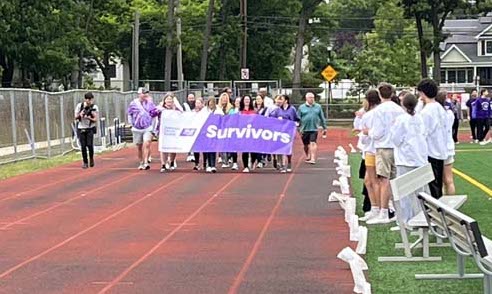 Relay for life team walking on track
