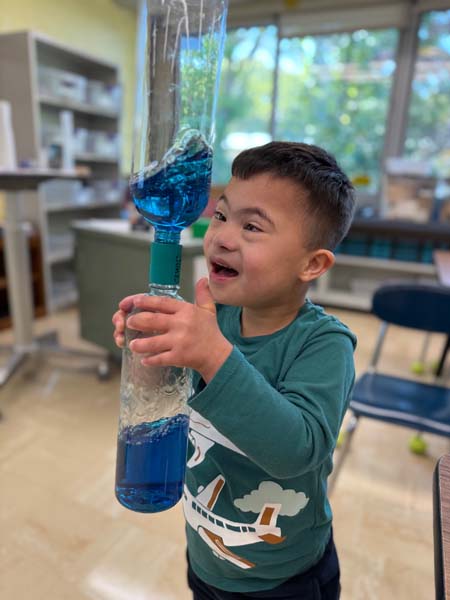 Student shaking a bottle with liquid