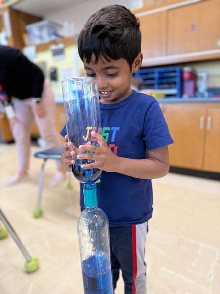 Student shaking a bottle with liquid