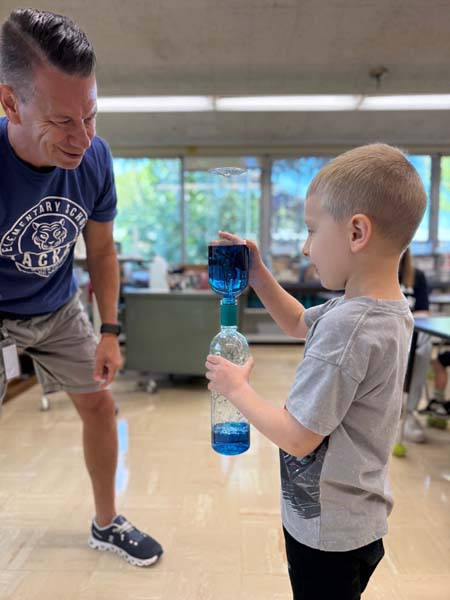 Student shaking a bottle with liquid