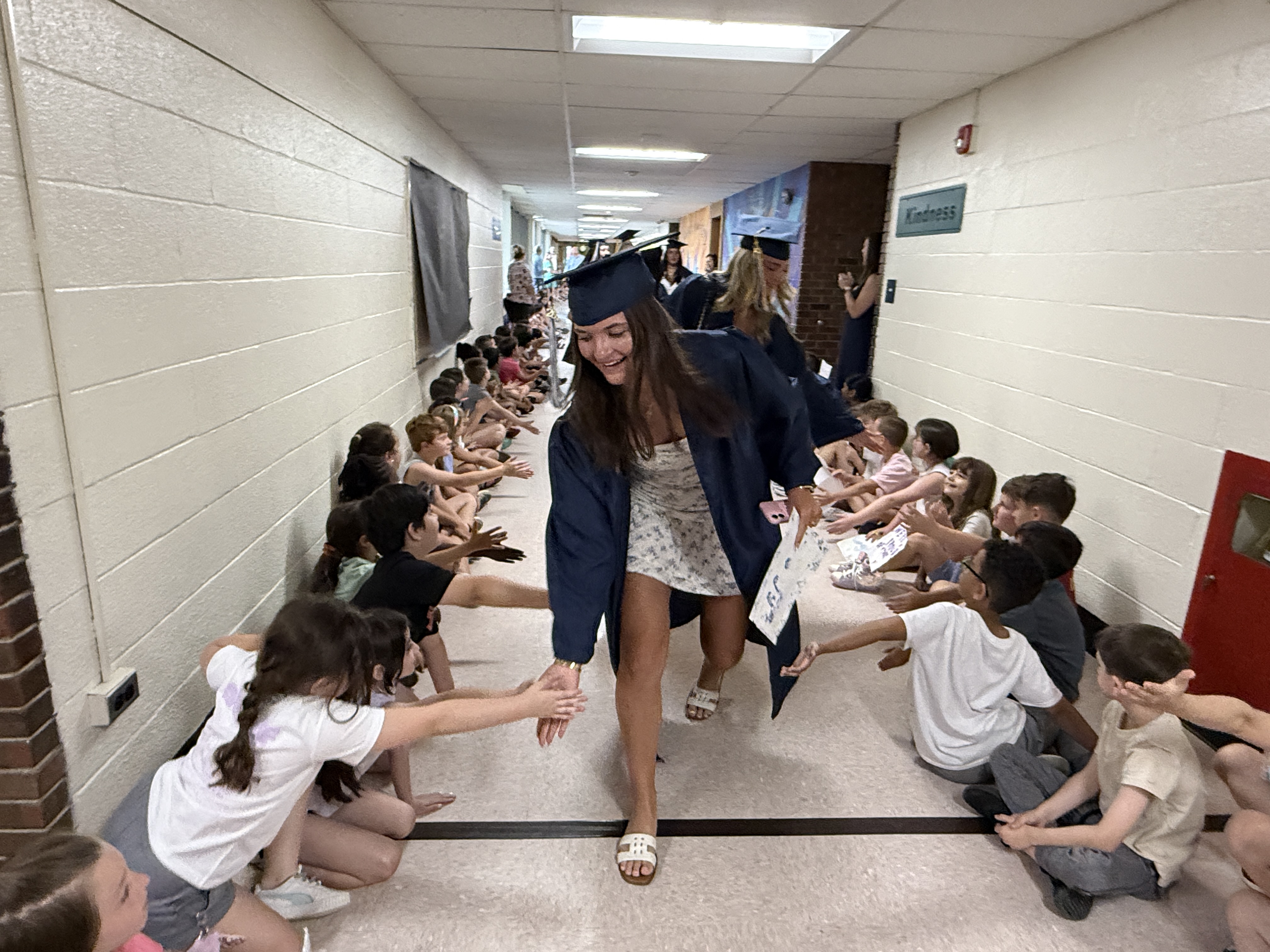 student giving high fives