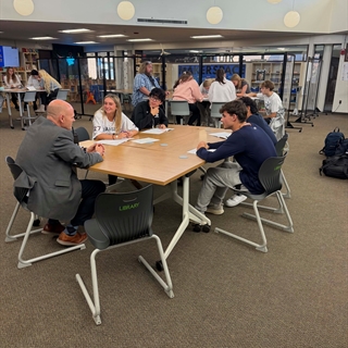 students at a table talking