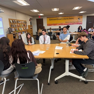 students at a table talking