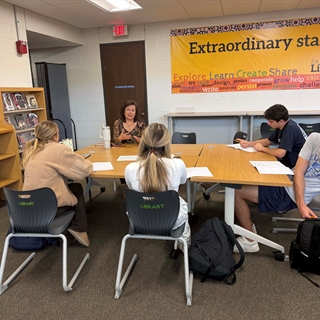students at a table talking