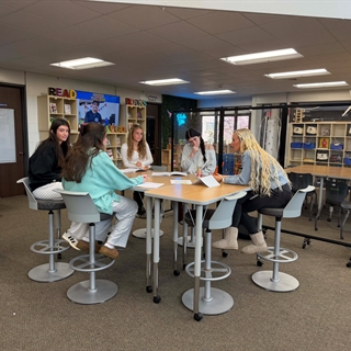 students at a table talking