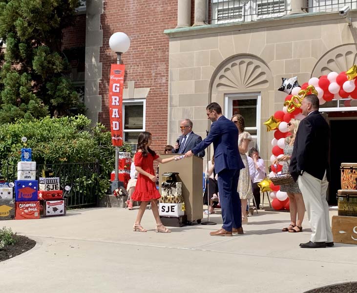 student walking after getting diploma