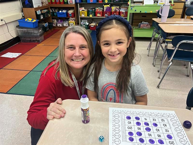 Student and teacher posing for picture