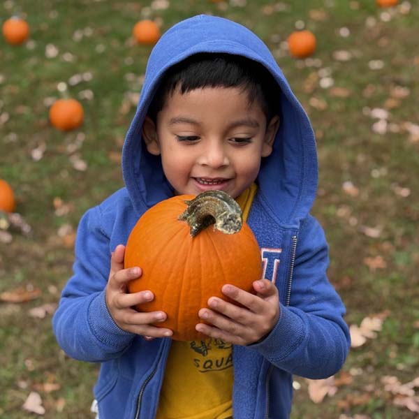Students holding pumpkins