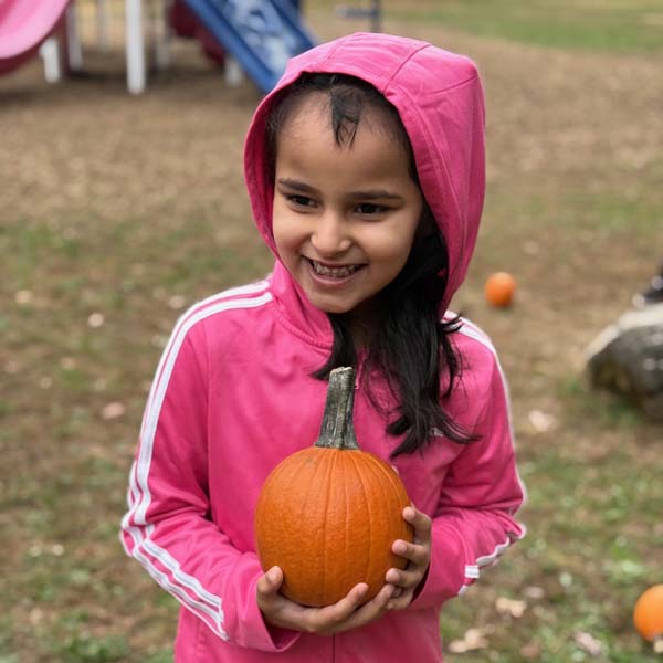 Students holding pumpkins