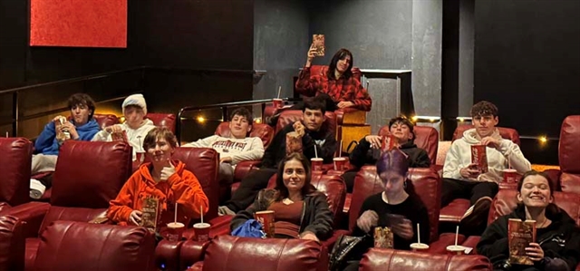 students in movie theatre posing for picture