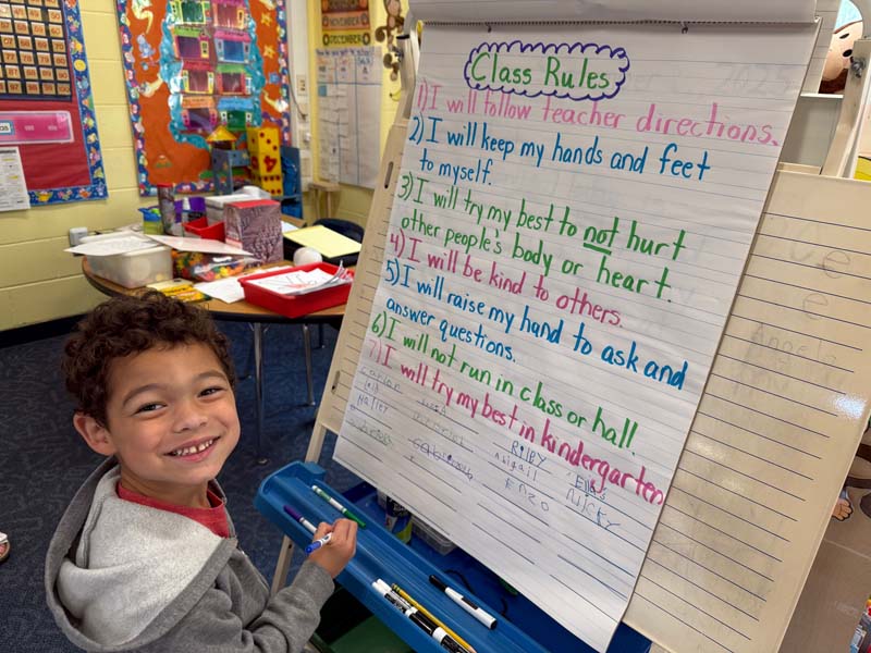 Student signing class rules