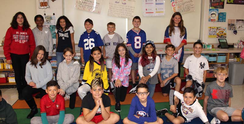 Dogwood Elementary students smile in classroom while participating in Red Ribbon Week