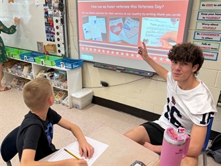 Students pointing at board