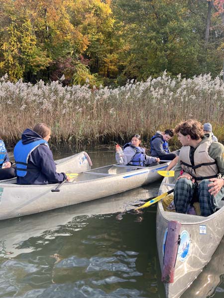 students on canoe