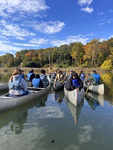 students on canoe