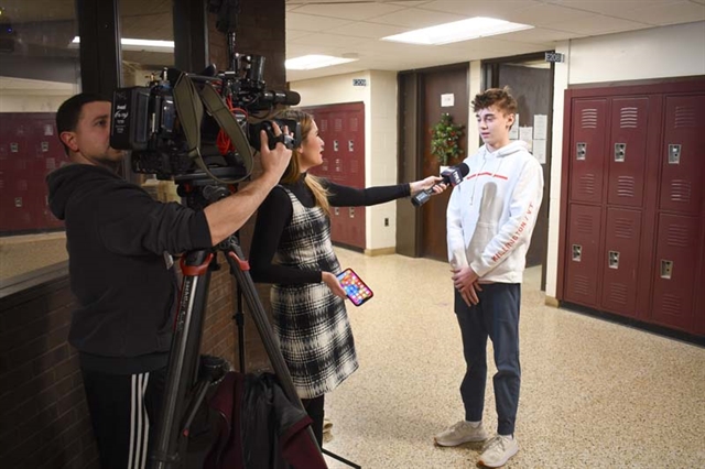 FOX 5 crew interviewing High School student