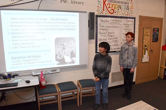 students presenting in front of the class