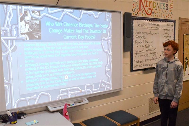 student presenting in front of the class