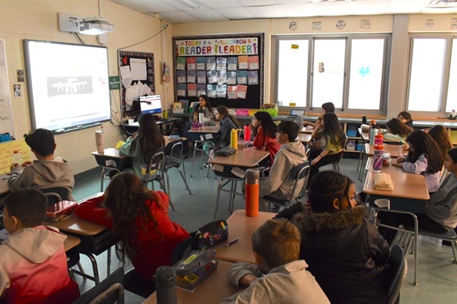 Students watching NASA expert on screen