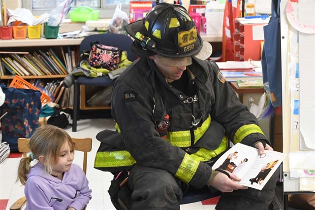 Firefighter dad reading his book