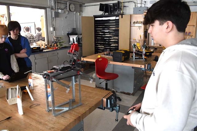 student operating robot